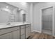 Bright bathroom featuring a double sink vanity, modern fixtures, and a walk-in closet for ample storage space at 776 Nw Palm Frond Way # 55, Calabash, NC 28467