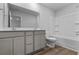 Well-lit bathroom with wood-look flooring, gray vanity with double sinks, toilet and shower-tub combination at 776 Nw Palm Frond Way # 55, Calabash, NC 28467