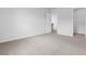 Bright bedroom featuring neutral carpet, white walls, and doorway at 776 Nw Palm Frond Way # 55, Calabash, NC 28467