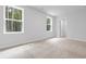 Bright bedroom with plush carpet, two windows and a door to the closet at 776 Nw Palm Frond Way # 55, Calabash, NC 28467