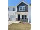 Inviting townhome entrance featuring gray accents, white siding, and a well-manicured lawn for added curb appeal at 776 Nw Palm Frond Way # 55, Calabash, NC 28467