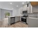 Modern kitchen featuring stainless steel appliances, grey cabinets and granite countertops at 776 Nw Palm Frond Way # 55, Calabash, NC 28467