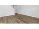 This living room features wood-look flooring and access to the staircase at 776 Nw Palm Frond Way # 55, Calabash, NC 28467