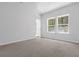 Bright bedroom featuring neutral carpet, a window providing natural light, and light-colored walls at 786 Nw Palm Frond Way # 51, Calabash, NC 28467