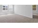 Bright bedroom, two windows, and neutral carpet, enhanced by the soft glow of natural light at 786 Nw Palm Frond Way # 51, Calabash, NC 28467