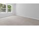 This room with neutral carpet, large window, and light-colored walls is ready for your personal touch at 786 Nw Palm Frond Way # 51, Calabash, NC 28467