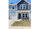 Charming two-story home with blue siding, a garage, and a well-manicured lawn at 786 Nw Palm Frond Way # 51, Calabash, NC 28467
