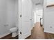 Hallway with white doors, baseboards, and wood-look flooring at 786 Nw Palm Frond Way # 51, Calabash, NC 28467