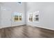 Bright living room with hardwood floors, a high ceiling, and many windows at 786 Nw Palm Frond Way # 51, Calabash, NC 28467