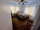 This cozy bedroom features hardwood floors, a ceiling fan, and bright natural lighting at 8 Raymond St., Andrews, SC 29510