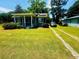 Beautiful one-story house with front porch, black shutters, well-manicured lawn, and driveway at 8 Raymond St., Andrews, SC 29510
