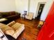 Inviting living room with hardwood floors, a comfortable couch and two arm chairs at 8 Raymond St., Andrews, SC 29510