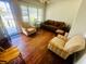 Bright living room featuring wood floors, ample seating, and natural light from the window at 8 Raymond St., Andrews, SC 29510