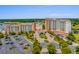 Stunning aerial view of a resort featuring multiple buildings, lush landscaping, parking, and a nearby golf course at 8121 Amalfi Pl. # 4706, Myrtle Beach, SC 29572