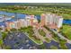 Picturesque aerial view of a luxurious resort with waterway access, showcasing its multiple buildings, parking, and golf course at 8121 Amalfi Pl. # 4706, Myrtle Beach, SC 29572