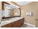 Bathroom with double sink vanity, large framed mirror, and well-lit vanity at 8121 Amalfi Pl. # 4706, Myrtle Beach, SC 29572