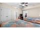 Bright bedroom with two beds, television, and access to more rooms at 8121 Amalfi Pl. # 4706, Myrtle Beach, SC 29572