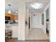 Hallway view leads to the kitchen and bedroom showcasing tile floors, neutral walls, and attractive lighting at 8121 Amalfi Pl. # 4706, Myrtle Beach, SC 29572