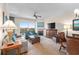 Bright living room with a fireplace, modern furnishings, balcony access, and a stylish ceiling fan at 8121 Amalfi Pl. # 4706, Myrtle Beach, SC 29572