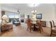 Comfortable living room with fireplace, fan, balcony access, and an inviting dining area at 8121 Amalfi Pl. # 4706, Myrtle Beach, SC 29572