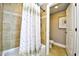 Bathroom featuring decorative tile, a shower curtain, and a toilet in an alcove at 8121 Amalfi Pl. # 7-805, Myrtle Beach, SC 29572