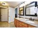 This bathroom features double sinks, granite counters, decorative mirrors, and a tile floor at 8121 Amalfi Pl. # 7-805, Myrtle Beach, SC 29572