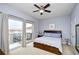 Cozy bedroom with balcony access, ceiling fan and soft, light-colored walls at 8121 Amalfi Pl. # 7-805, Myrtle Beach, SC 29572