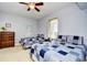 This bedroom features two beds with lovely blue and white patchwork quilts and a ceiling fan at 8121 Amalfi Pl. # 7-805, Myrtle Beach, SC 29572
