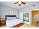 Comfortable bedroom featuring ceiling fan, large mirror and view to attached bath at 8121 Amalfi Pl. # 7-805, Myrtle Beach, SC 29572