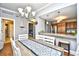 Bright dining area with modern chandelier, wood table, and views into the kitchen and bedroom at 8121 Amalfi Pl. # 7-805, Myrtle Beach, SC 29572