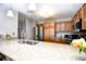 Stylish kitchen showcasing granite counters, wooden cabinetry and modern stainless appliances at 8121 Amalfi Pl. # 7-805, Myrtle Beach, SC 29572