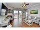 Comfortable living room featuring neutral decor, a fireplace, and balcony access offering partial views at 8121 Amalfi Pl. # 7-805, Myrtle Beach, SC 29572