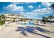 Enjoy the view from the community pool with a bridge crossing, trees, and a backdrop of fluffy clouds at 8121 Amalfi Pl. # 7-805, Myrtle Beach, SC 29572