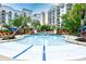 The spacious resort-style pool is surrounded by lounge chairs, lush landscaping and large palm trees at 8121 Amalfi Pl. # 7-805, Myrtle Beach, SC 29572