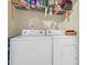 Functional laundry room features a washer, dryer, and shelving for organized storage at 837 Triple Ct. # 837, Myrtle Beach, SC 29588