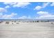 Wide sandy beach with people enjoying a sunny day under a partly cloudy sky at 9400 Shore Dr. # 124, Myrtle Beach, SC 29572