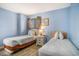 Bedroom featuring two beds with blue walls and a window at 9400 Shore Dr. # 124, Myrtle Beach, SC 29572