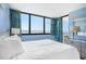 Comfortable bedroom showcasing ocean views from a large window and a balcony at 9400 Shore Dr. # 124, Myrtle Beach, SC 29572