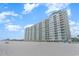 High-rise condominium building with a pristine white facade along the beach at 9400 Shore Dr. # 124, Myrtle Beach, SC 29572