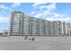 White high-rise condo building on the beach offering stunning ocean views at 9400 Shore Dr. # 124, Myrtle Beach, SC 29572