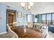 Spacious dining area featuring a wooden table, an adjacent living room, and a bathroom view at 9400 Shore Dr. # 124, Myrtle Beach, SC 29572