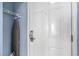 A view of the entrance door with an ironing board holder on the adjacent wall at 9400 Shore Dr. # 124, Myrtle Beach, SC 29572