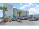 Multi-story condominium building with ample parking and a view of palm trees on a sunny day at 9400 Shore Dr. # 124, Myrtle Beach, SC 29572