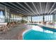 Indoor pool area featuring a unique design, multiple tables and chairs, and natural light at 9400 Shore Dr. # 124, Myrtle Beach, SC 29572