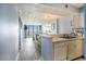 Kitchen view leads into a living room featuring a sofa, ocean view balcony, and dining area at 9400 Shore Dr. # 124, Myrtle Beach, SC 29572