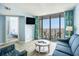Comfortable living room with access to a balcony with beach views and an adjacent bedroom at 9400 Shore Dr. # 124, Myrtle Beach, SC 29572