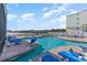 Outdoor pool area with lounge chairs, lift, and meticulously maintained landscaping at 9400 Shore Dr. # 124, Myrtle Beach, SC 29572