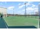 Outdoor tennis courts on a sunny day, surrounded by landscaping and distant buildings at 9400 Shore Dr. # 124, Myrtle Beach, SC 29572