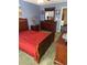Comfortable bedroom with wood furniture, red bedding, and decorative wall art at 9779 Leyland Dr. # 3, Myrtle Beach, SC 29572