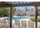 Stunning community pool with lounge chairs and a view of the clubhouse on a sunny day at 9779 Leyland Dr. # 3, Myrtle Beach, SC 29572